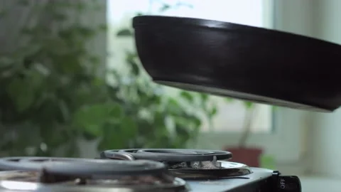 The pan is placed on the stove Stock Footage 142930196