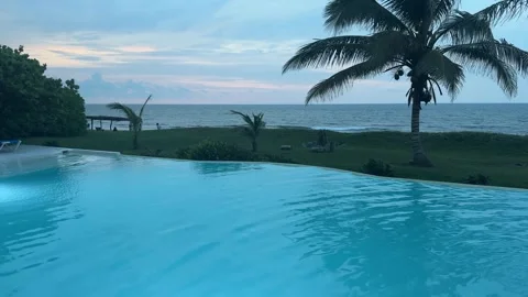 Pan of Pool with Lights Overlooking Ocean and Palms – Nautla, Veracruz Stock Footage 314976872
