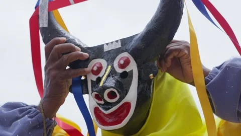 A pan puts on a Traditional mask of a Dancing Devil in a religious celebration 動画素材 312912148
