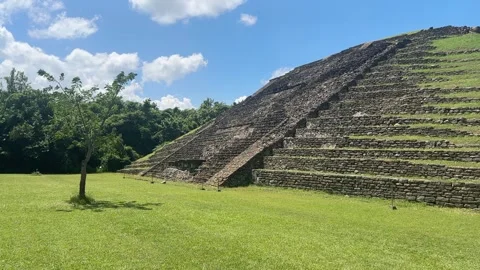 Pan of pyramid with tree, grass, and blue sky, Tajín Mexico, August 2 2025 Stock Footage 315004517