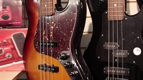 Pan rack focus row of bass guitars Stock Footage 69111197