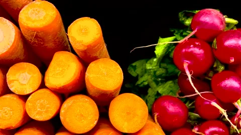 Pan of raw fresh carrots and beets on display in a retail grocery store Stock Footage 174871174