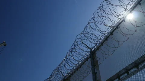 Pan of razor wire atop the US Border at Otay Mesa Stock-Footage 48406521
