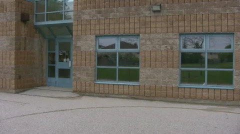 Pan of a red bricked school with playground Stock Footage 533571