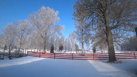 Pan of Red Houses and Red Fence in the Snow Stock Footage