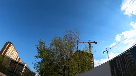 Pan of residential building under construction with immobile construction crane Stock Footage 243035592