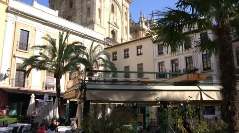 Pan up of restaurants in front of the central Cathedral in Granada, Spain. 库存影片 57331870