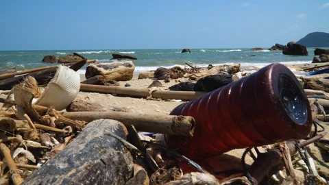 Pan revealing a large amount of plastic trash littering the seashore Stock Footage 107047274