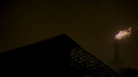 Pan right across night sky with factory fire smoke stack in background Stock Footage 89945379