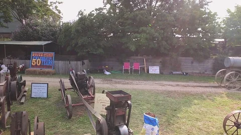 Pan Right of Antique, Early 20th Century Farm Machinery Exhibit Stock Footage 79794012