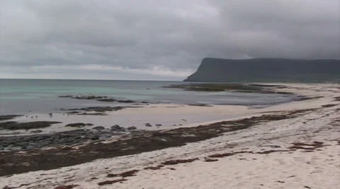 Pan right on arctic beach with cliff in the opposite side Stock Footage 37313574