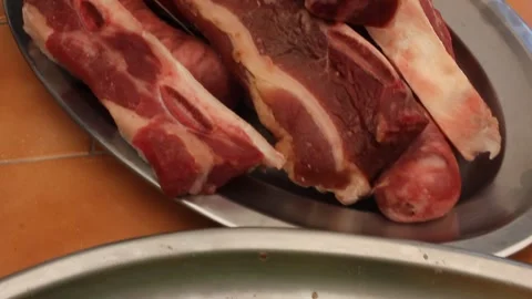 Pan right camera movement from spiced pineapple slices to raw beef ribs and Stock Footage 340534087
