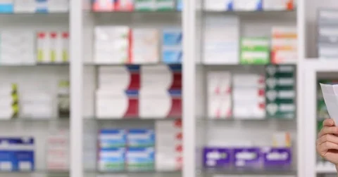 Pan Right Closeup Serious Medic Woman Reading Pills Instructions Magnifying Lens Stock Footage 72792559