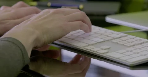 Pan right from female hands typing to mouse and hand moves to use mouse Stock Footage 68446754