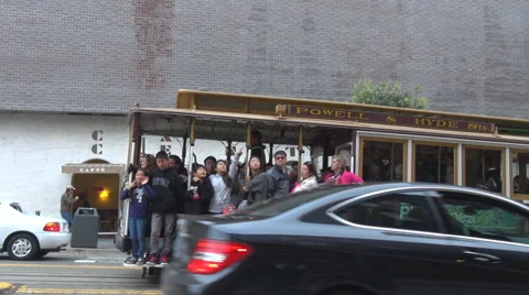 Pan right follow of cable car full wagon up hill San Francisco public transport Stock Footage 65479314