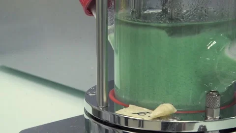 A Pan right of green liquid in big test tube Stock Footage 155533046