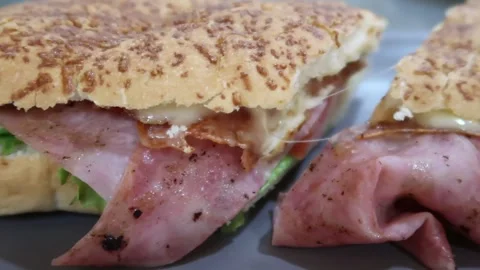 Pan to the right of ham ciabatta with cheese and lettuce Stock Footage 263062012
