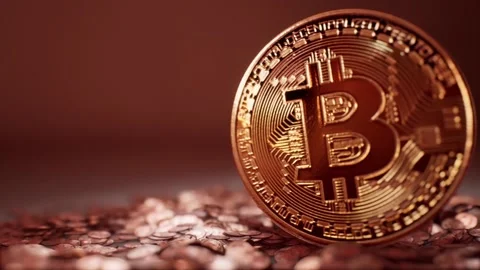 A Pan right of huge bitcoin upright in pile of smaller bitcoins Stock Footage 155221363