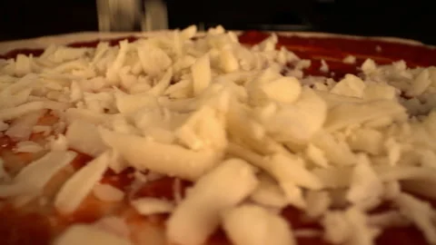 Pan Right to Left of Chef Dropping Cheese Onto Pizza Dough Video stock 130410815