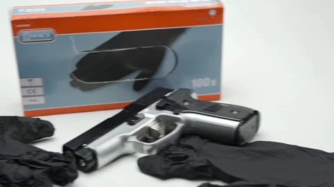 Pan From Right To Left Disposable Gloves And Gun Stock Footage 126015452
