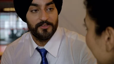 Pan right to left face portrait closeups as colleagues talk and discuss at co-wo Stock Footage 102082563