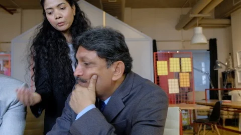 Pan right to left as office colleagues having disagreement with their boss  Stock Footage 104586389