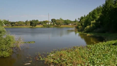 Pan right to left over lake at Booker Creek Park on a  Sunny afternoon in St. Pe Stock Footage 273957317