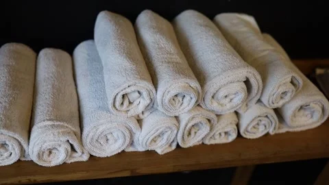 Pan Right To Left Shot Of White Rolled Hand Towels In A Metal Container Video stock 170885072