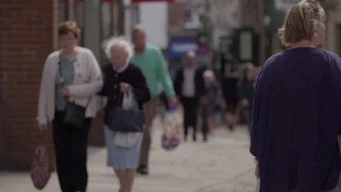 Pan right to left. Soft Focus Older age Crowds in English City 動画素材 77615329