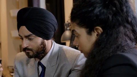 Pan right to left as sympathetic advice and guidance from a senior boss manager  Stock Footage 102081743