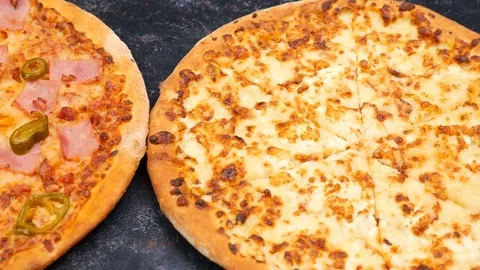 Pan from right to left on three homemade pizzas Stock Footage 84785936