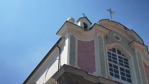 Pan right low angle view of Italian church facade against blue sky Stock Footage 346722285