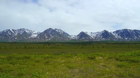 Pan Right, Mountain Range with Green Field 2 Stock Footage 37396593