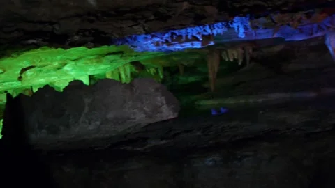 Pan right of natural cave formation with ceiling meeting ground rocks in shallow Stock-Footage 160813283