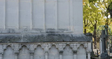 Pan right from ornate crypt to view of cemetery with man walking Vídeos de archivo 169313596