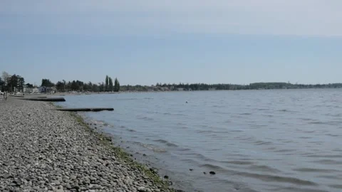 Pan right to the Pacific Ocean seen from the shoreline of Birch Bay, WA Stock Footage 241198315