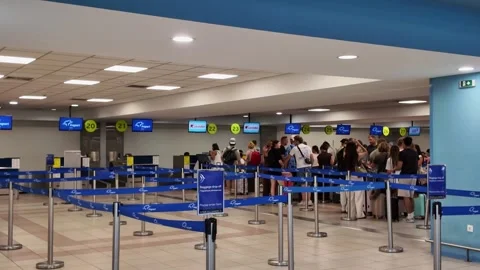 Pan Right of Queue of Passengers at Airport Check-in Stock Footage 341431701