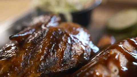 Pan right of ribs covered in BBQ sauce  動画素材 112575856