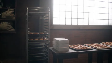Pan-right shot of an empty bakery with doughnuts on table, Winston-Salem, North- Stock Footage 238867835