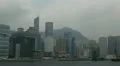 Pan Right Shot of Hong Kong Skyline with Skyscrapers and Boats Cloudy Rainy Day HD Footage