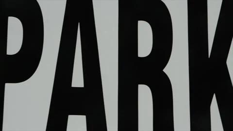 Pan right on sign caption that says no parking, really large in frame, black Stock Footage 246135804