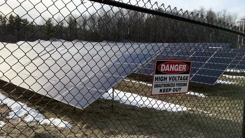 Pan right of small roadside solar farm during winter Stock Footage 88302563