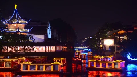 Pan Right Time Lapse of People Ride in Tour Boats on River Travel Nanjing Night Video stock 106067950