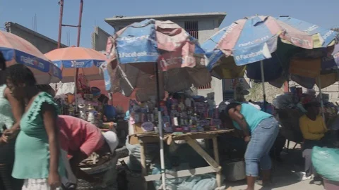 Pan right of traffic at intersection in Petion-Ville. Can see the Stock Footage 112503982