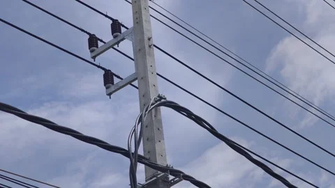 Pan right video of cut twisted aerial cables on a concrete pole ready. Stock Footage 345203573