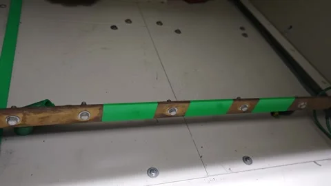 Pan right video of a solid copper grounding with green safety indicators. Stock Footage 338298525