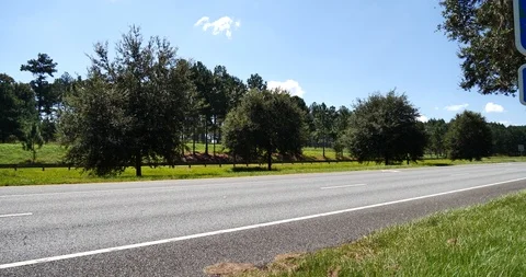 Pan right wide angle CU reveal Florida border sign, Desantis Governor Stock Footage 118158909