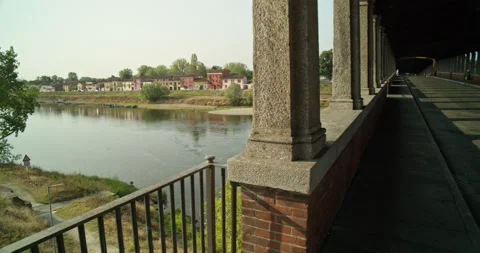 Pan from River to Inside the Main Covered Bridge in Pavia, Italy Stock Footage 202624385