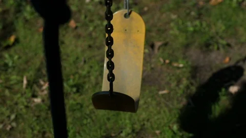 Pan up rust weathered swing chain in garden outdoor summer in gentle breeze m Video stock 95032715