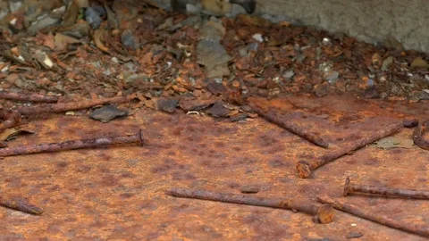 Pan: Rusty old nails on a decaying steel table, ruste steel work bench, rust Stock Footage 89307022